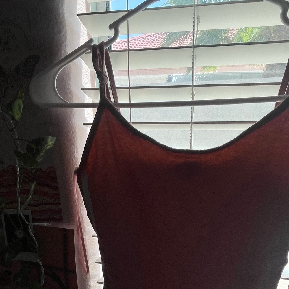 Pink button from bottom shirt